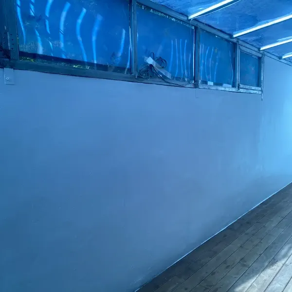창 아래 긴 벽면이 깨끗하게 정리된 베란다